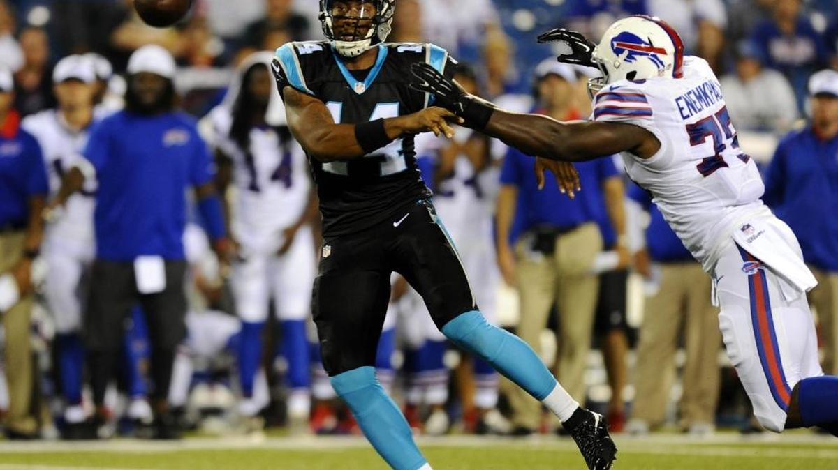 
Under pressure, Carolina’s Joe Webb (14) throws the pass to Brandon Wegher that ended up as a 42-yard TD. Carolina won 25-24, with Webb leading a 91-yard TD drive and throwing a two-point conversion pass for the deciding points. 
