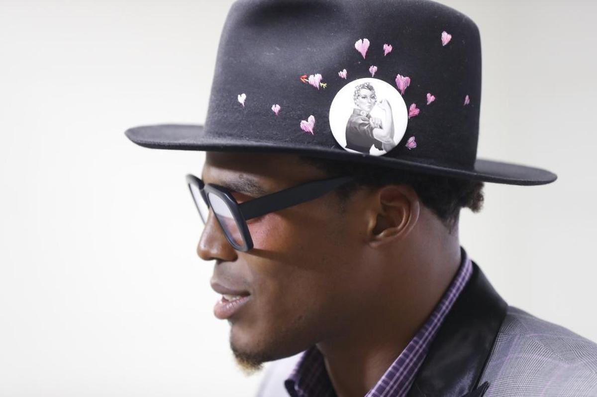Carolina quarterback Cam Newton wore a Rosie the Riveter pin in his hat Sunday while addressing the media.