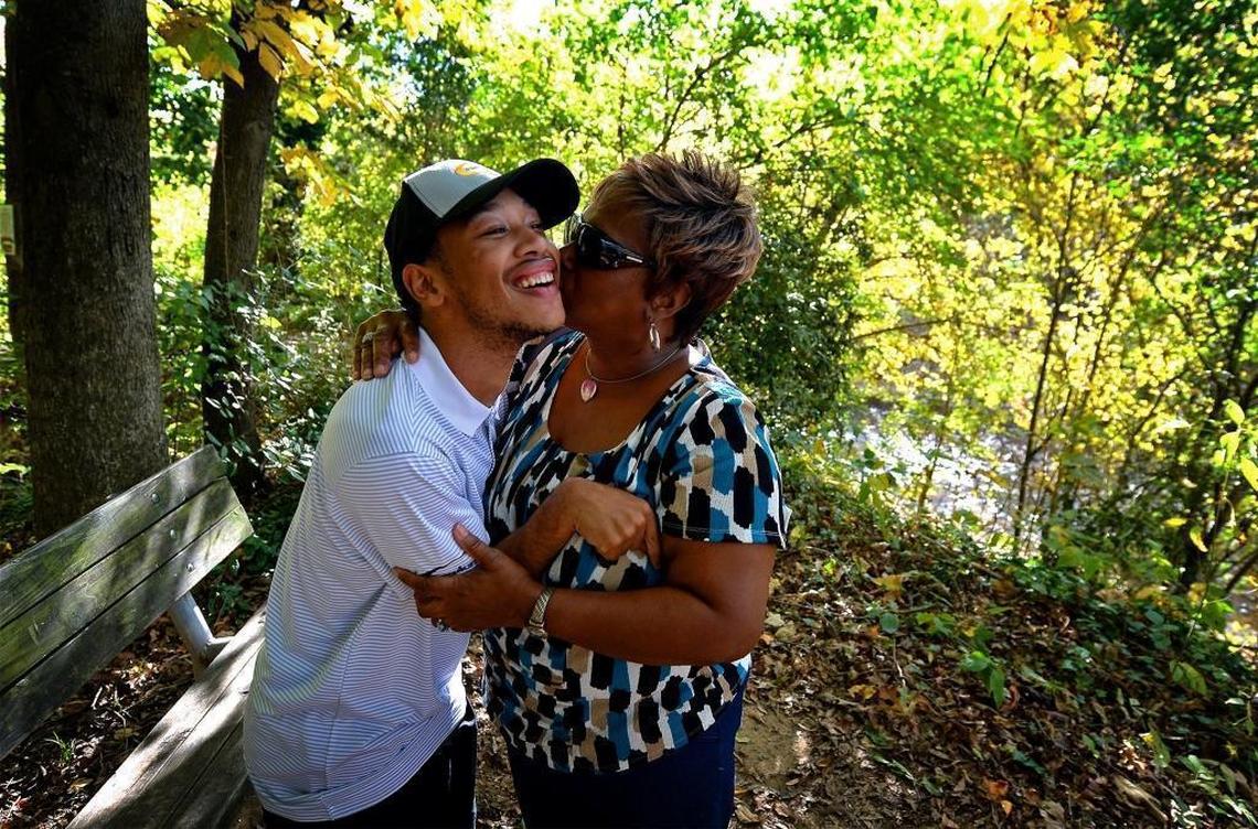 Chancellor Lee Adams, left, receives a kiss from his grandmother and caregiver, Saundra Adams, at Freedom Park in Charlotte in early November.