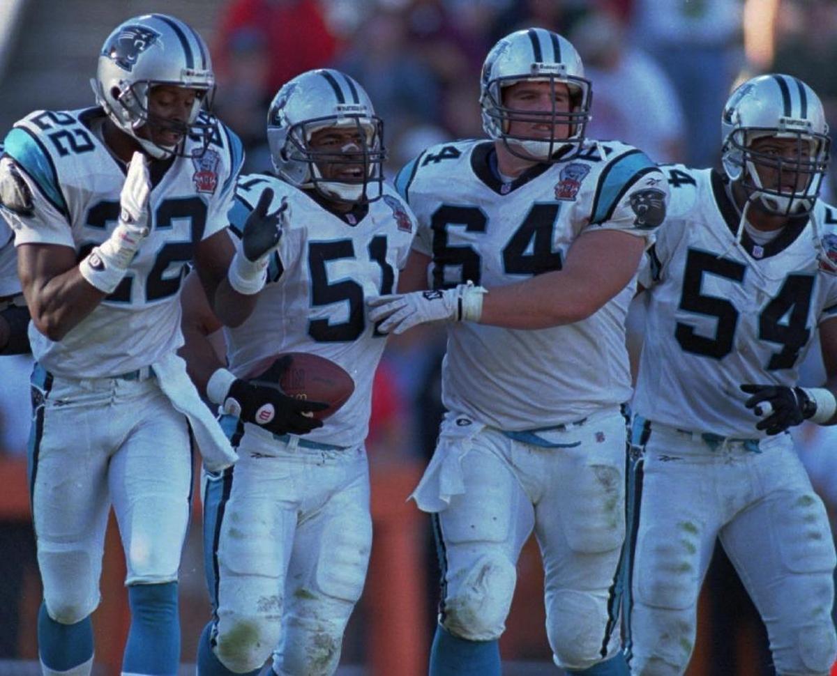 Sam Mills (51) celebrated with teammates after he scored on a 36-yard interception return against the New York Jets in 1995. Mills’ play was the signature event in Carolina’s first-ever win -- a 26-15 victory over the Jets in Clemson, S.C.