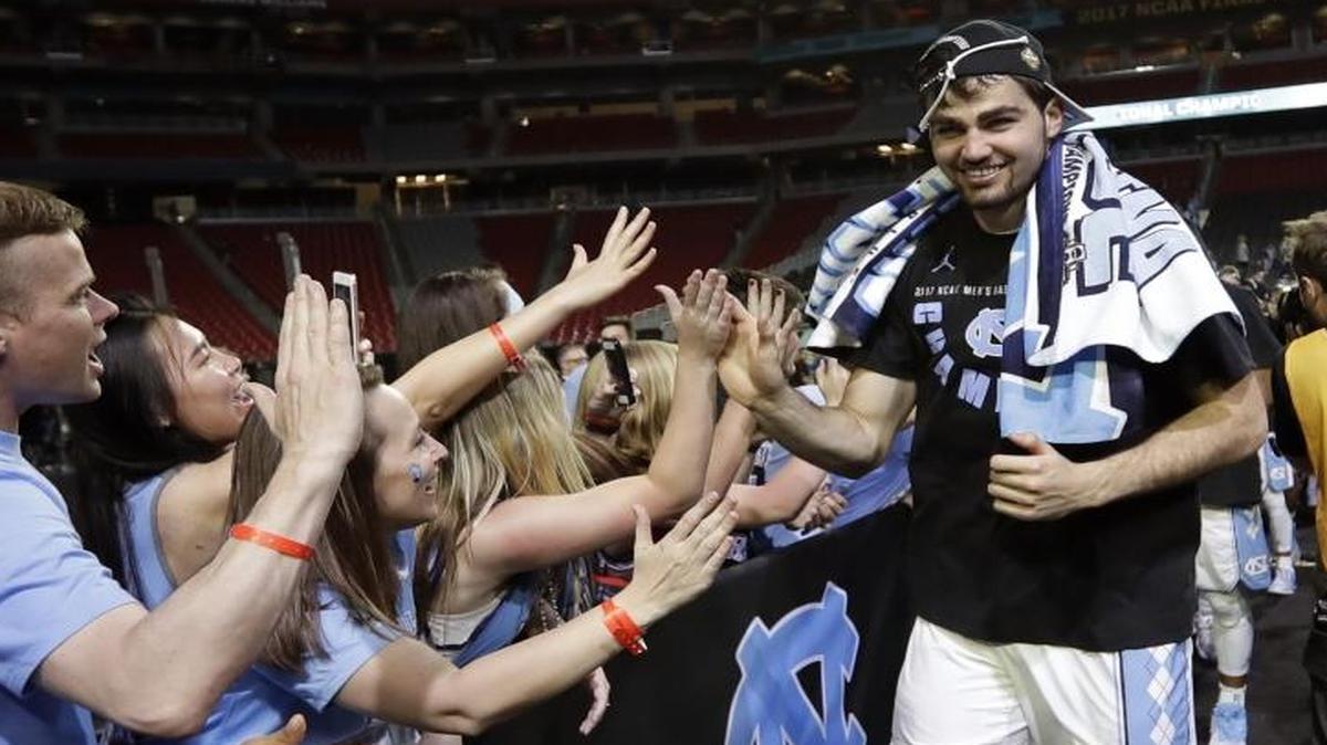 North Carolina forward Luke Maye celebrates with UNC fans after the championship game against Gonzaga Monday. The Tar Heels, won, 71-65.