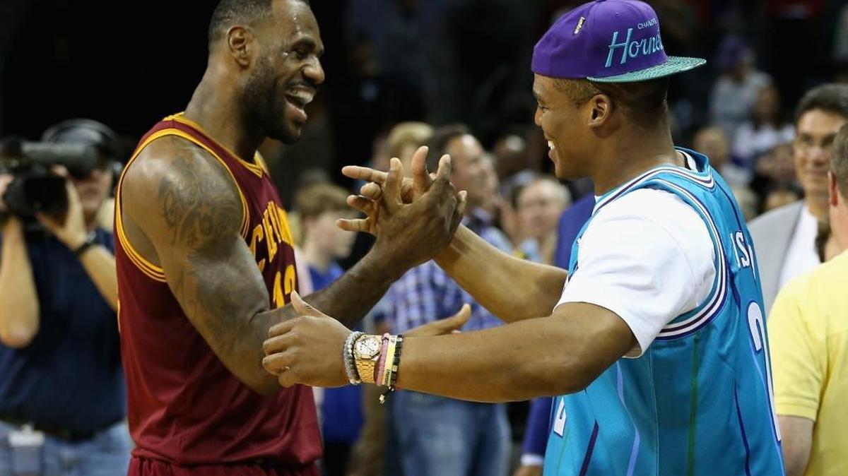 Cleveland Cavaliers star LeBron James talks to Carolina Panthers quarterback Cam Newton after Friday’s game at Time Warner Cable Arena. The Cavs defeated the Hornets, 95-90.