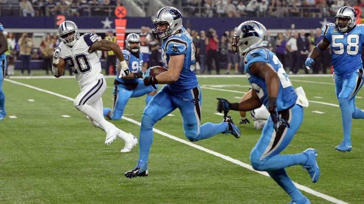 Carolina Panthers linebacker Luke Kuechly (59) looks to score a touchdown after intercepting a Dallas Cowboys' Tony Romo (9) pass in the second quarter at AT&T Stadium on Thursday.