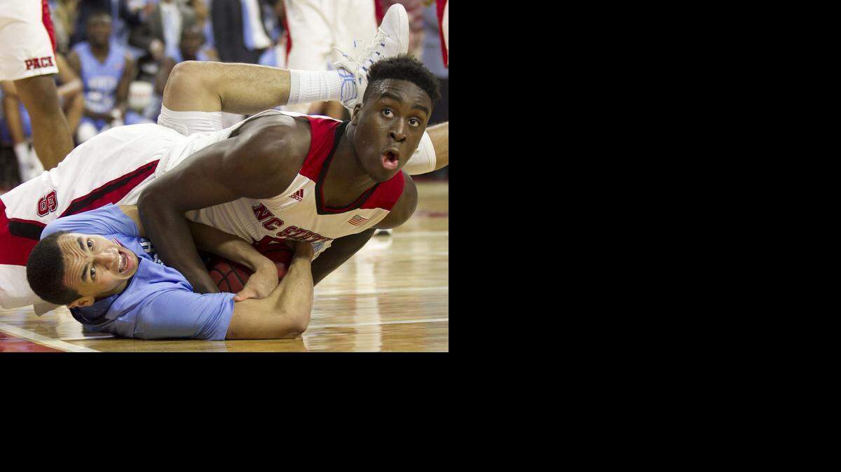 
UNC, N.C. State and Duke have all made the Sweet 16 and will all fight for spots in the Final Four this weekend. In this photo from mid-January, North Carolina's Marcus Paige, left, and North Carolina State's Abdul-Malik Abu get tangled during a battle for a loose ball. 
