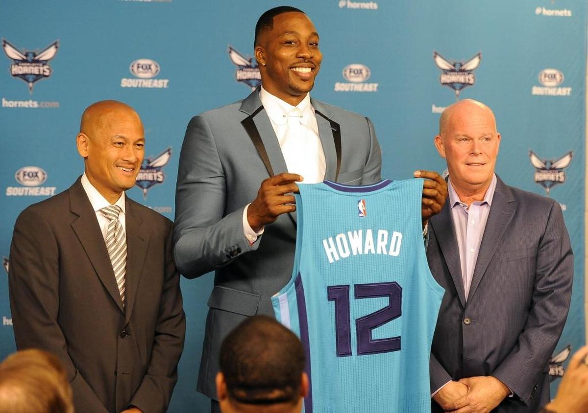 Rich Cho (left) generally fared better as the Charlotte Hornets’ GM when he made trades as compared to when he used high draft picks. Cho traded for Dwight Howard (center) in 2017 as coach Steve Clifford looked on.