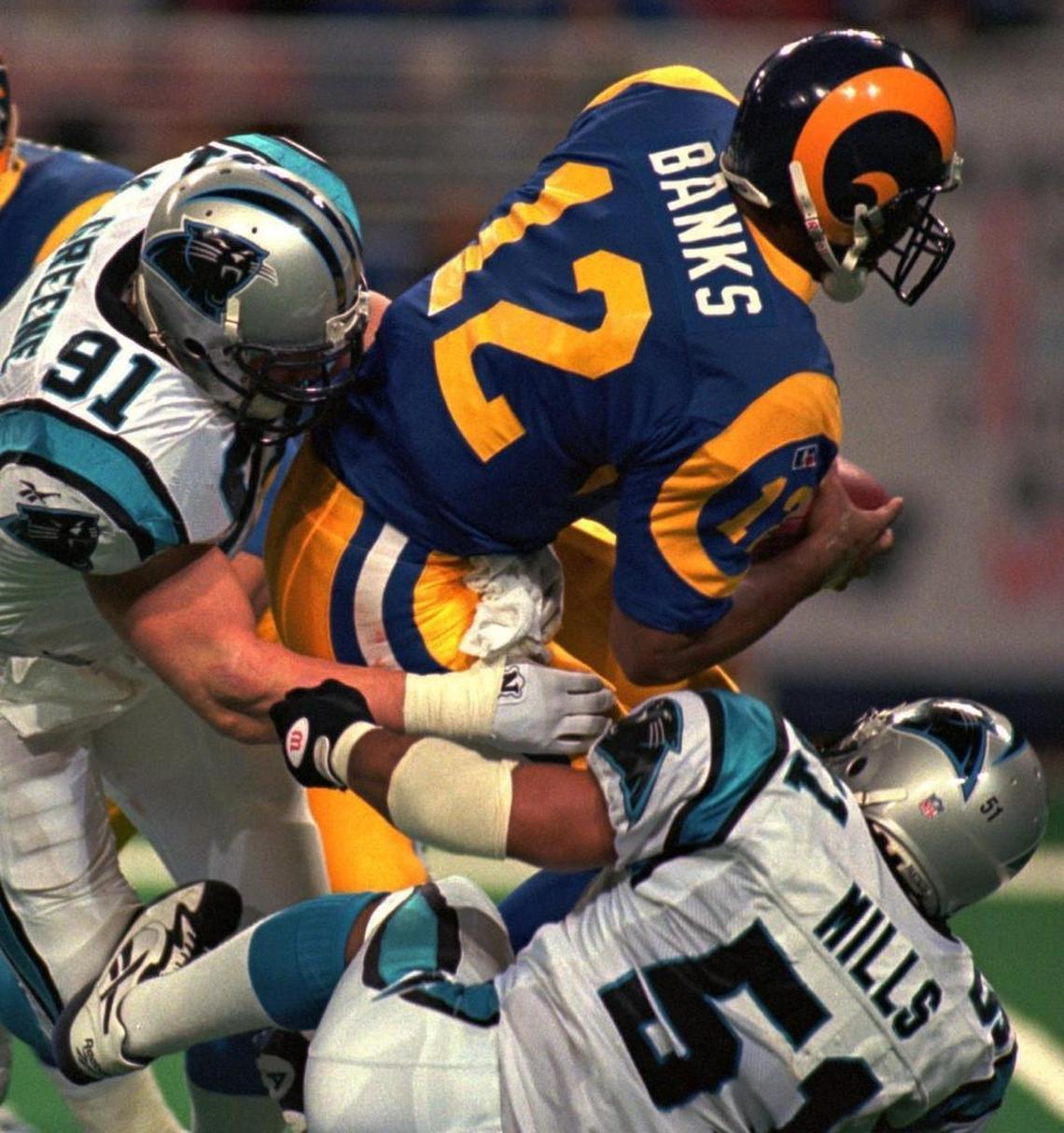 Kevin Greene (91) and Sam Mills (51) took down St. Louis quarterback Tony Banks for a quarterback sack in 1996. Greene is the only current member of the Pro Football Hall of Ffame on the Panthers’ top 20 list, although he eventually will be joined by several more Carolina players once they retire.