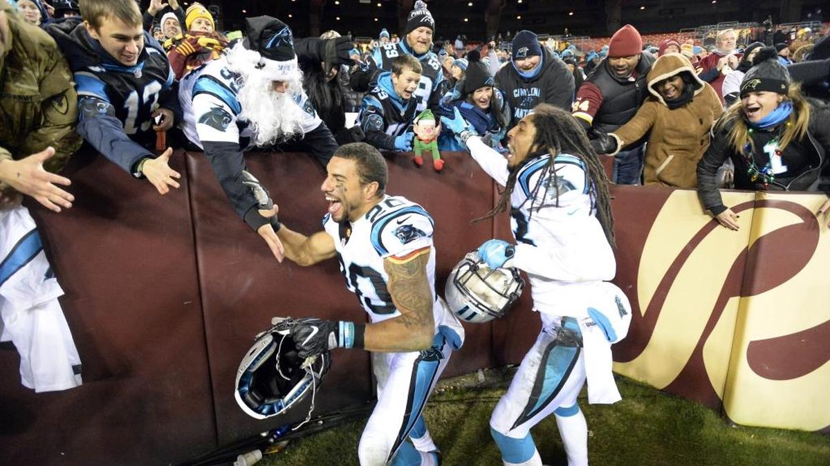 Carolina Panthers strong safety Kurt Coleman (20) and free safety Tre Boston (33) celebrate with fans as they leave the field after dealing Washington a 26-15 loss on Monday.