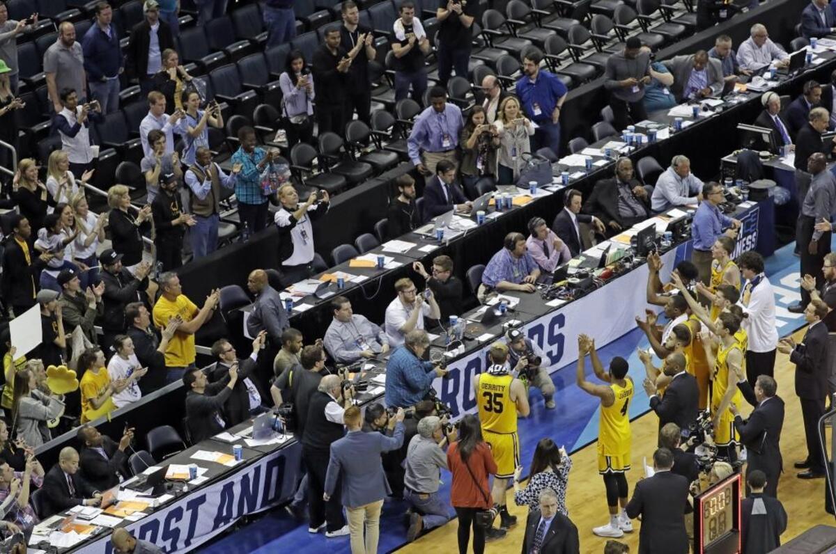UMBC players salute their fans after losing 50-43 to Kansas State Sunday. A No. 16 seed, UMBC pulled the first “16 vs. 1” upset in NCAA tournament history Friday night against Virginia but couldn’t recapture the magic against Kansas State.