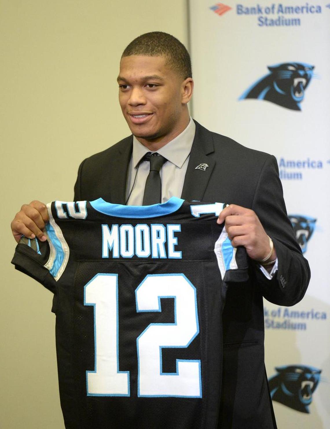 D.J. Moore, the Carolina Panthers' top pick in the 2018 NFL Draft, smiles as he holds up his jersey Friday after meeting the media at Bank of America Stadium. The former Maryland wide receiver was the 24th overall pick Thursday.