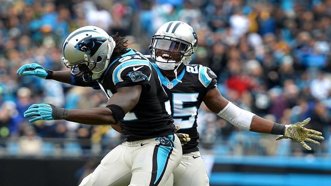 Carolina Panthers cornerback Charles Tillman, left, and cornerback Bené Benwikere celebrate a defensive stop against the Green Bay Packers on Sunday. The Panthers defeated the Packers 37-29 to move to 8-0.