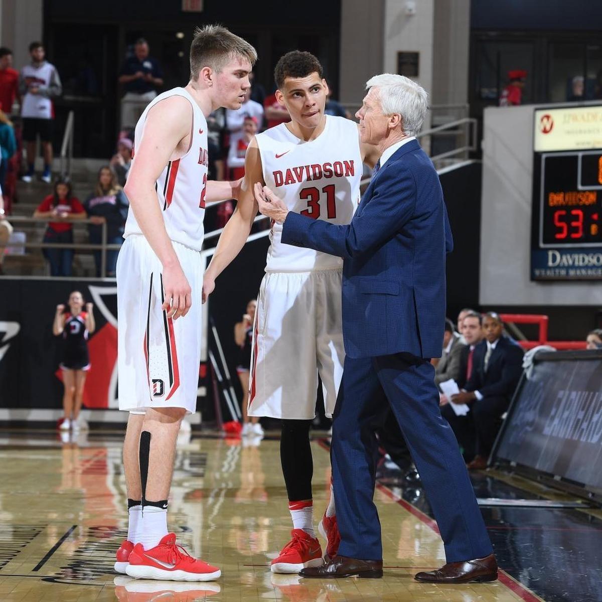 Davidson coach Bob McKillop huddles with Kellan Grady (31) and Peyton Aldridge in a game earlier this season. The Wildcats secured an NCAA tournament berth Sunday afternoon and will play Kentucky in Boise, Idaho, on Thursday.