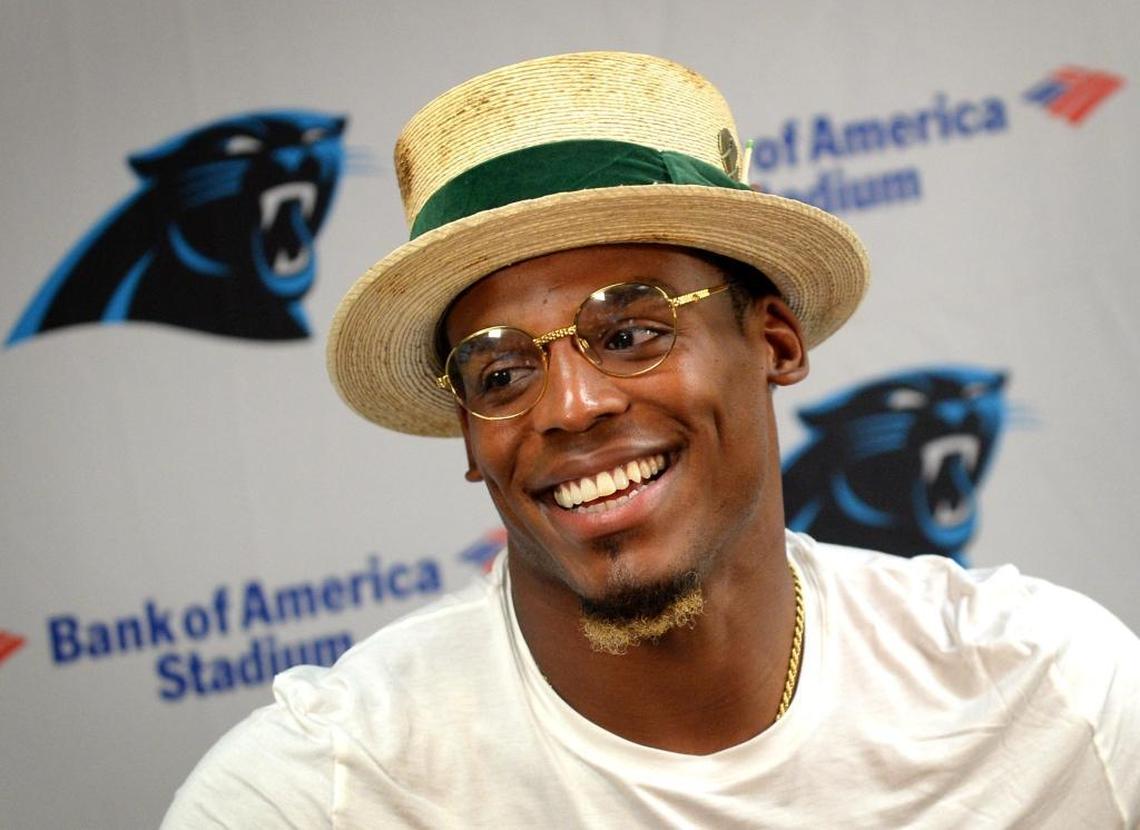 Carolina Panthers quarterback Cam Newton laughs as he responds to a reporter's question Thursday.