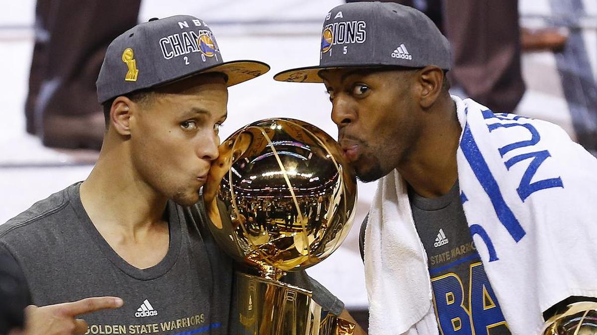 Golden State Warriors Stephen Curry, left, and Andre Iguodala, the NBA Finals MVP, celebrate with the Larry O’Brien Trophy after Game 6 in Cleveland, June 17, 2015. The Warriors defeated the Cleveland Cavaliers 105-97 to win the best-of-seven game series 4-2.