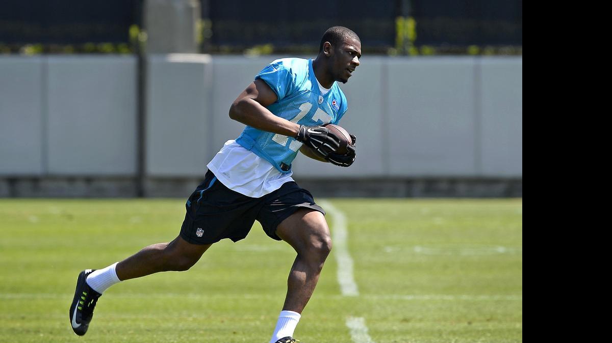 
Carolina Panthers rookie wide receiver Devin Funchess wears No. 17, the same number as former quarterback Jake Delhomme. Here he turns and runs upfield after catching a pass during the team's rookie minicamp in early May. 
