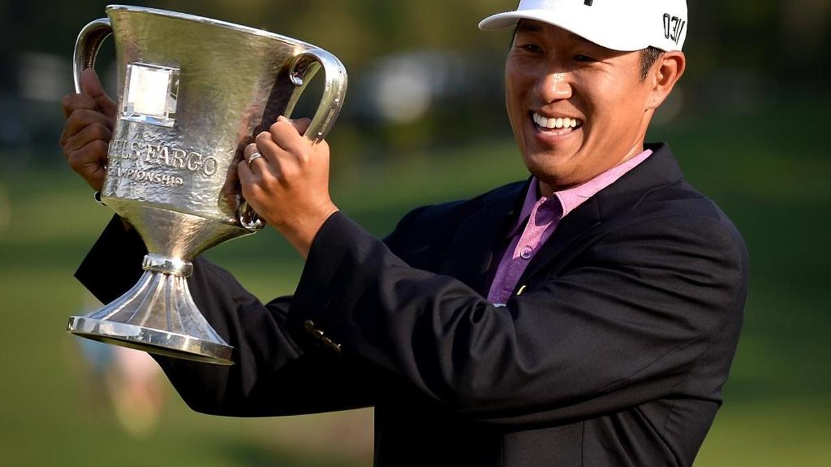 James Hahn hoists the Wells Fargo Championship trophy after defeating Roberto Castro in a one-hole playoff.