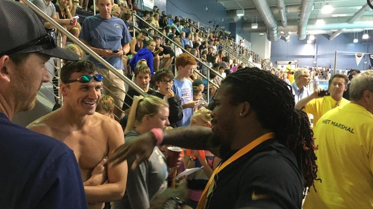 Ryan Lochte meets DeAngelo Williams (right) on Sunday at the Arena Pro Swim Series at Mecklenburg County Aquatic Center. “I thought you were taller!” Williams told Lochte.