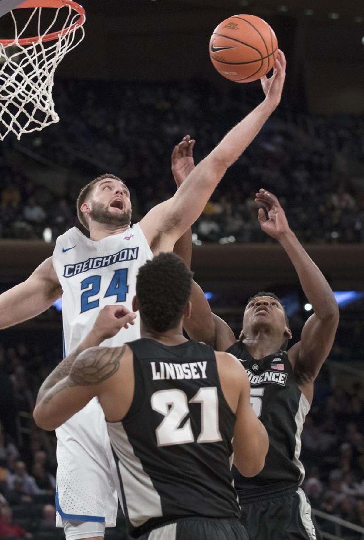 Creighton guard Mitch Ballock (24) fights for a rebound against Providence guard Jalen Lindsey (21) and forward Rodney Bullock during the 2018 Big East tournament.