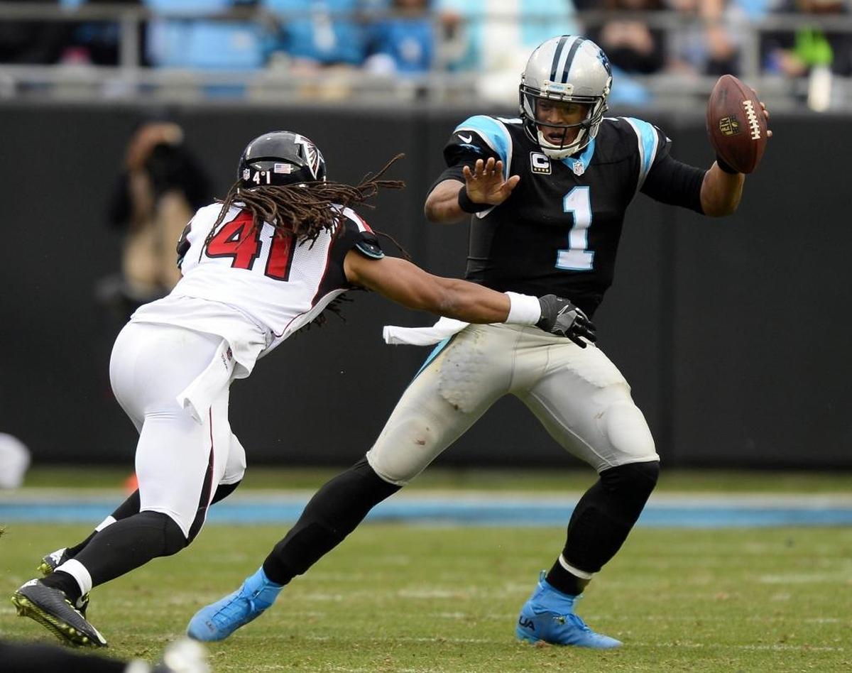 Carolina Panthers quarterback Cam Newton (1) worked to avoid Atlanta Falcons outside linebacker Philip Wheeler (41) in December 2016 in a game Atlanta won 33-16 -- beating the Panthers for the third time in a row.