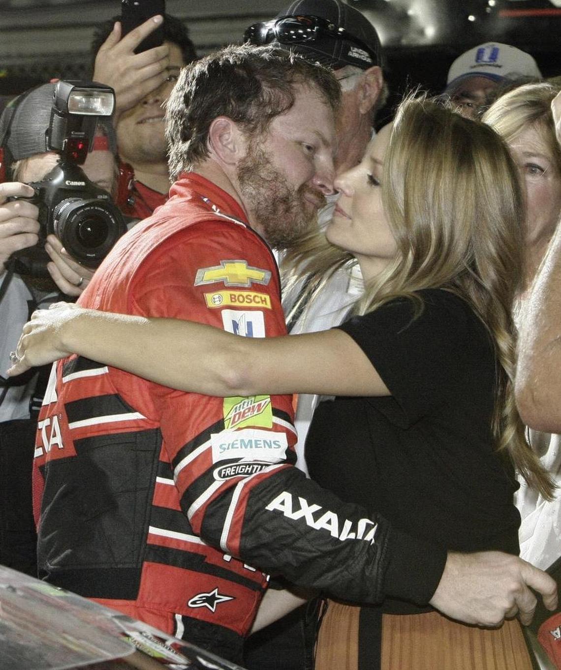 Dale Earnhardt Jr., left, hugs his wife Amy after finishing his final NASCAR race at Homestead, Fla., in November. Amy is due to have the couple’s first child in early May.