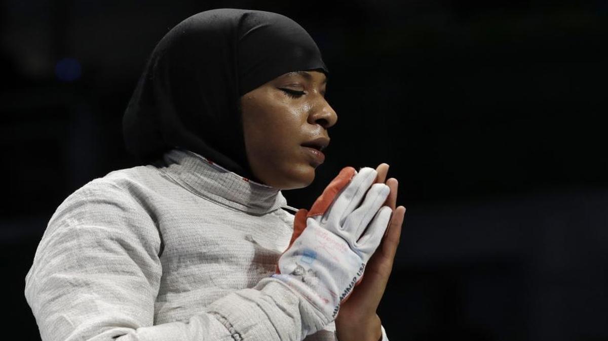 Former Duke fencer Ibtihaj Muhammad, the first American to compete in the Olympics wearing a hijab, reacts after losing against Cecilia Berder of France in the women’s individual saber fencing event on Monday.