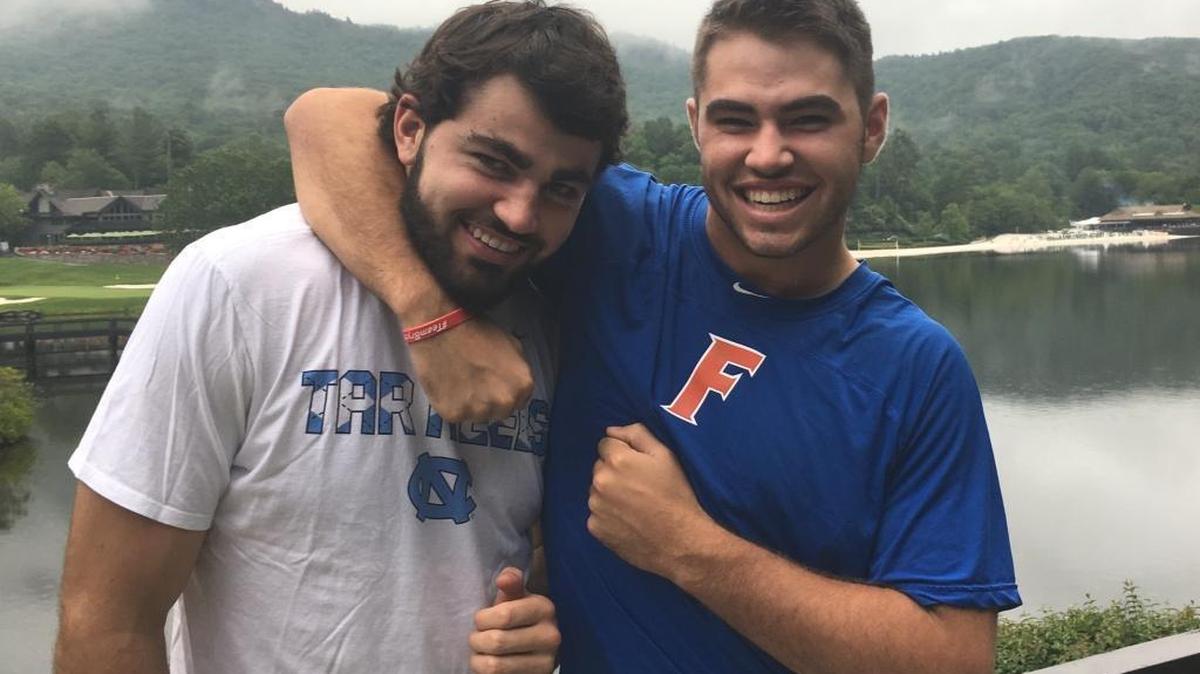 Cole Maye (right) puts his older brother Luke in a headlock. The brothers are only 15 months apart in age and look enough alike that Cole, a pitcher for Florida, is mistakenly told often these days that he played very well in North Carolina’s championship run.