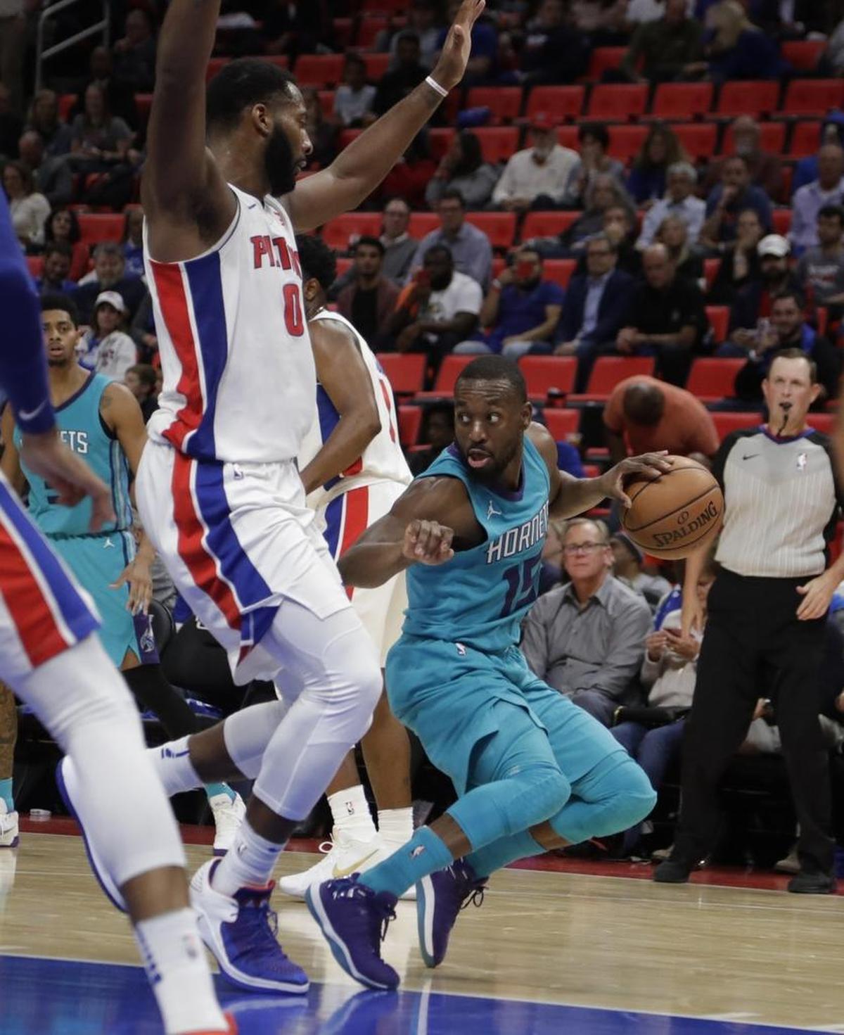 Charlotte Hornets guard Kemba Walker (right) is listed at 6-foot-1, which means he has to routinely navigate through giants like Detroit center Andre Drummond.