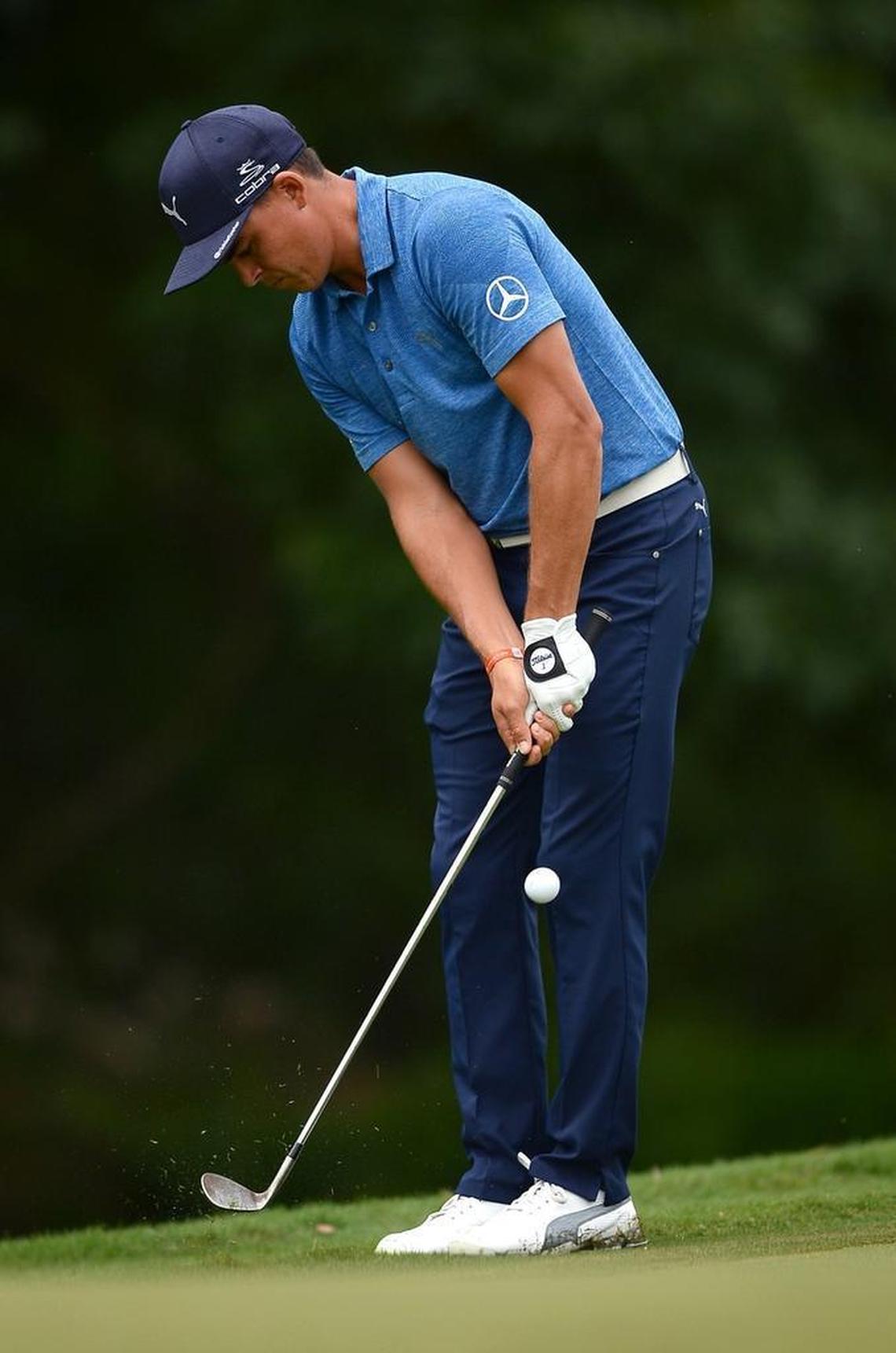 Rickie Fowler chips onto the 13th green during second-round action Friday at the PGA Championship at Quail Hollow Club. Fowler has shot rounds of 69 and 70 in the PGA’s first two days.