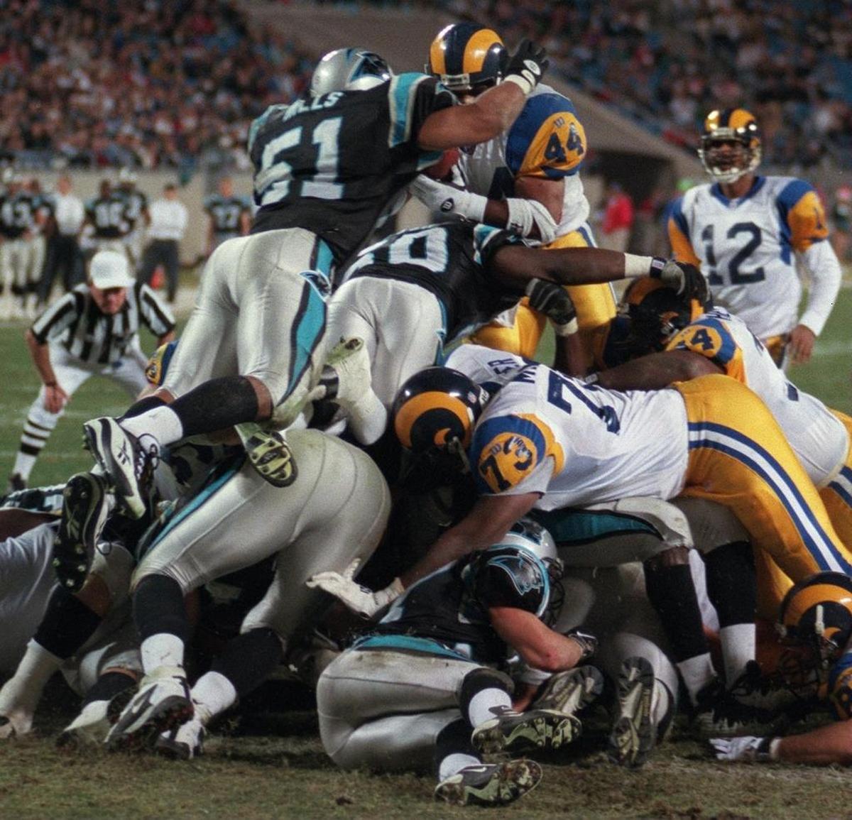 Although barely over 5-foot-9, linebacker Sam Mills (51) could elevate when needed, as he did on this play in 1997 to stop a St. Louis Rams running back short of the goal line.