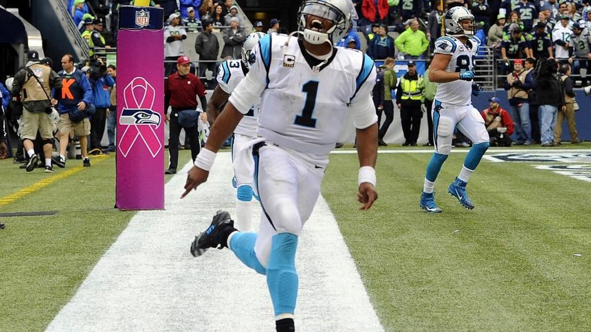 Carolina Panthers quarterback Cam Newton (1) celebrates throwing a game-winning touchdown to Greg Olsen (88) against the Seattle Seahawks in the fourth quarter at CenturyLink Field on Oct. 18. The Panthers won 27-23.