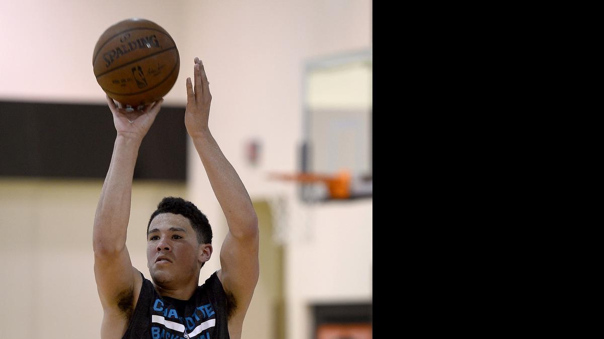 
Devin Booker releases a three-point shot during a pre-draft workout for the Charlotte Hornets on June 10, 2015. Booker played for Kentucky in college.
