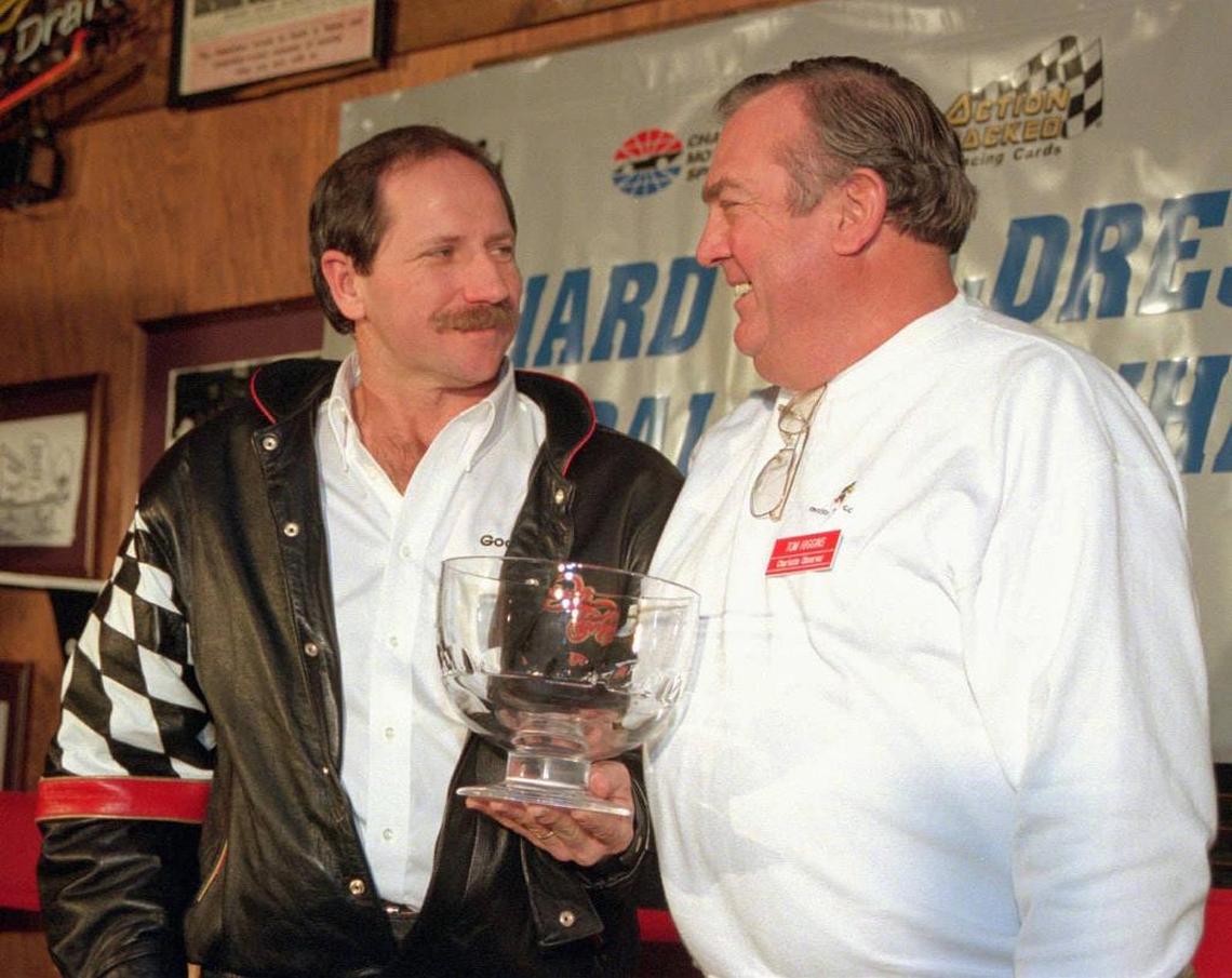 Dale Earnhardt accepts the Observer Cup, once given annually to the NASCAR Cup series driver who performed best at the then-eight races in the Carolinas, from Tom Higgins in 1995.