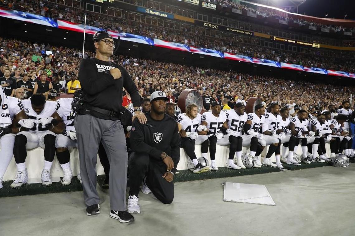 Some members of the Oakland Raiders kneel during the playing of the national anthem before an NFL game against Washington Sunday.