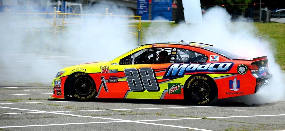 NASCAR driver Dale Earnhardt Jr. performs a burnout during an announcement that Maaco was partnering with Axalta to sponsor Earnhardt Jr.'s final NASCAR All-Star race car on Saturday night.