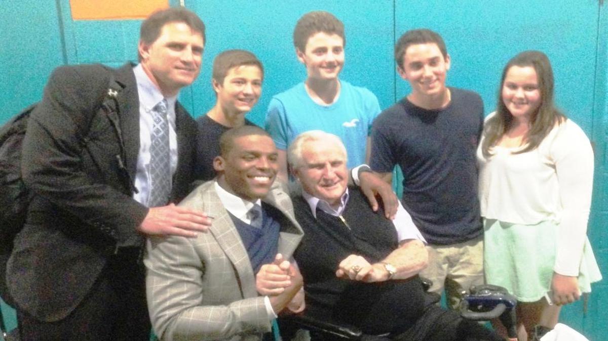 Panthers offensive coordinator Mike Shula (top left) poses with quarterback Cam Newton (seated, left), his father Don Shula (also seated) and members of the Shula family after the Panthers-Dolphins game in 2013 in Miami.