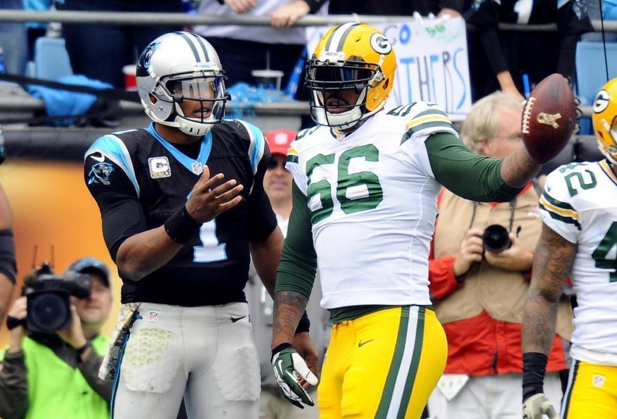 Cam Newton (left) and Julius Peppers were on opposite sides in this 2015 game, but they teamed up together for two seasons.