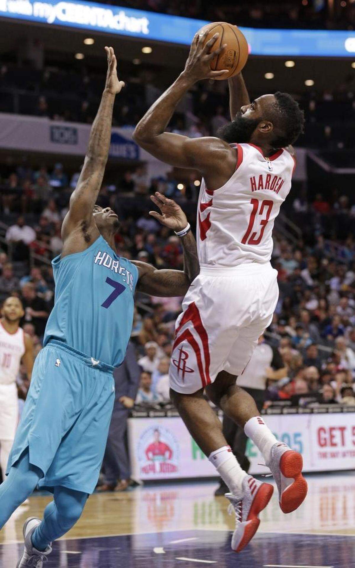 Houston’s James Harden (13) shoots over Charlotte’s Dwayne Bacon (7) during the second half Friday. Bacon scored one point in 29 minutes of play Friday, while Harden had a triple-double.