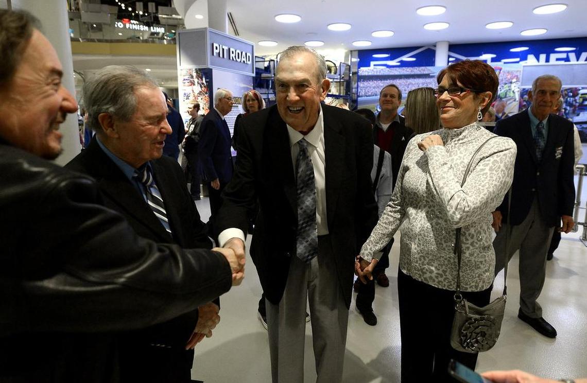 Former Charlotte Observer motorsports writer Tom Higgins and Linda Williams are greeted by (L-R) contemporaries Steve Waid and Barney Hall in 2015 at the NASCAR Hall of Fame. Higgins, who passed away Tuesday, was the 2015 recipient of the Squier-Hall Award for NASCAR Media Excellence.