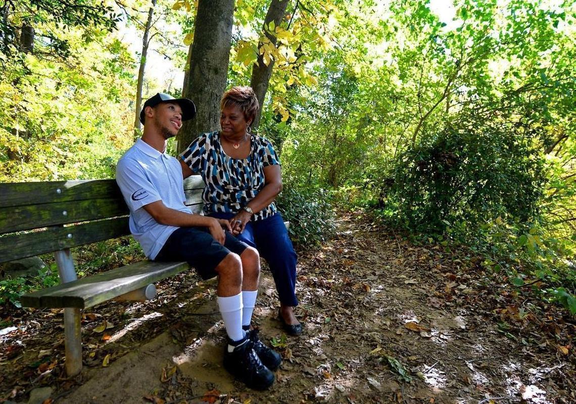 Chancellor Lee Adams, left and his grandmother, Saundra Adams, sit at Freedom Park in Charlotte in early November 2017. Adams has raised her grandson since birth. He calls her “G-Mom.”