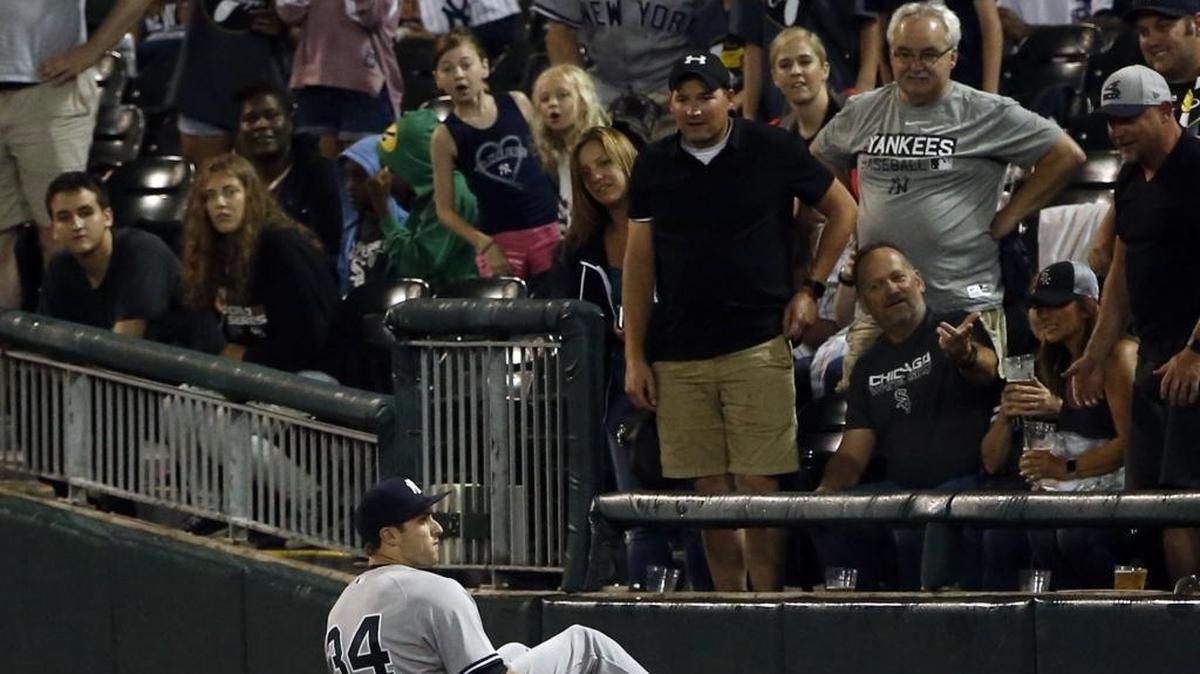 New York Yankees rookie Dustin Fowler sits on the field after suffering a season-ending injury during the first inning of his first-ever big-league game Thursday.
