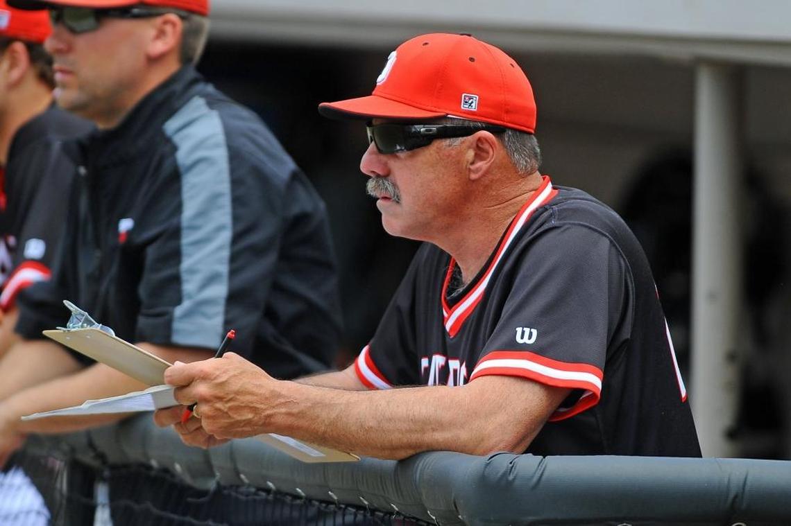 Davidson baseball coach Dick Cooke (center) watches a game from the dugout. Cooke, 61, will coach his 28th and final season for Davidson in 2018 before joining the school’s athletic department.