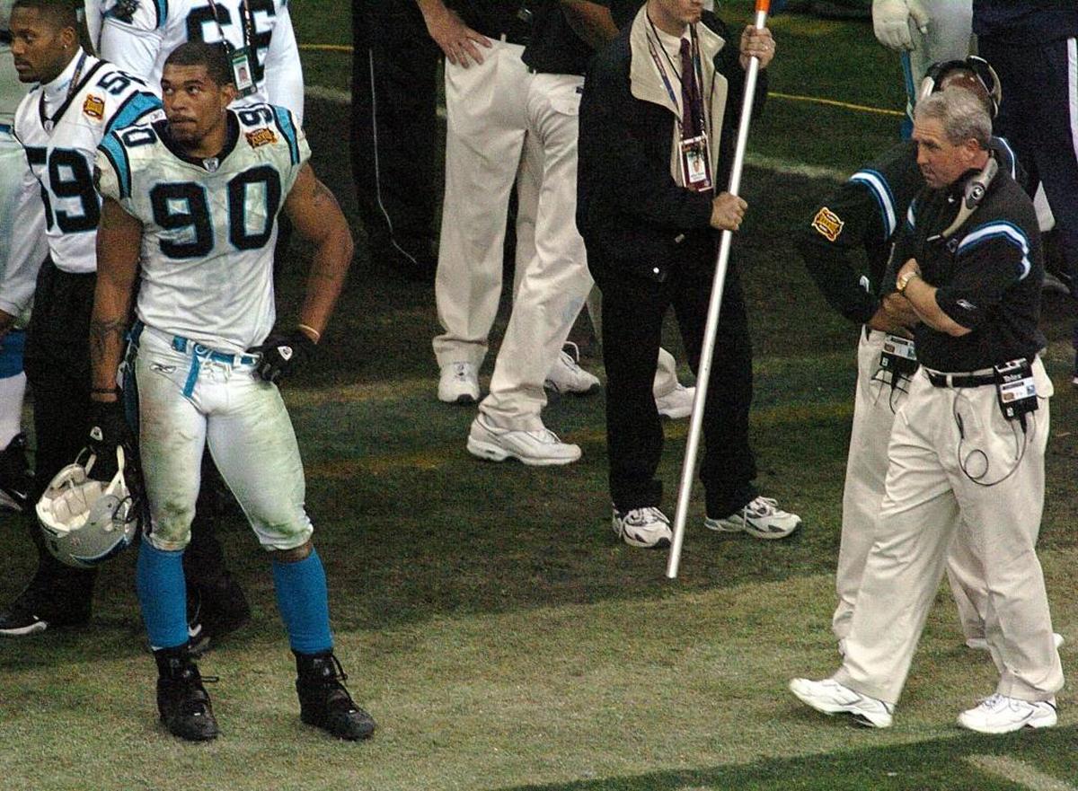 Julius Peppers (90) played for Carolina in the Super Bowl against New England following the 2003 season -- the only Panthers player on the current roster to do so. Coach John Fox (now the head coach of the Chicago Bears) is at right.