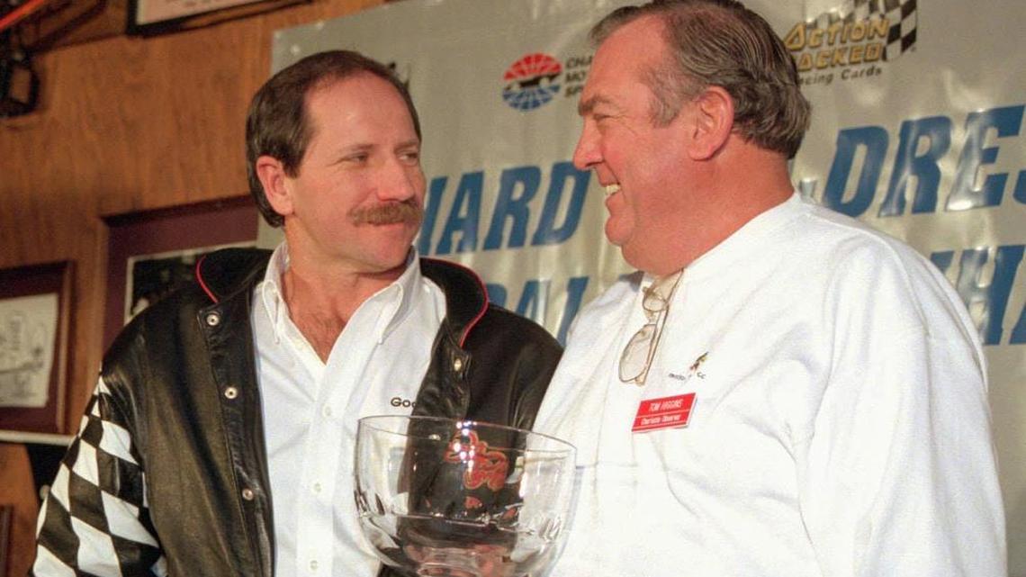 In this 1995 file photo, NASCAR legend Dale Earnhardt accepted the Observer Cup from Tom Higgins at an event in Charlotte. Higgins, now 80 and recovering from a stroke, was the first newspaper writer to cover every race in person in NASCAR’s top series when he did so for the Charlotte Observer.