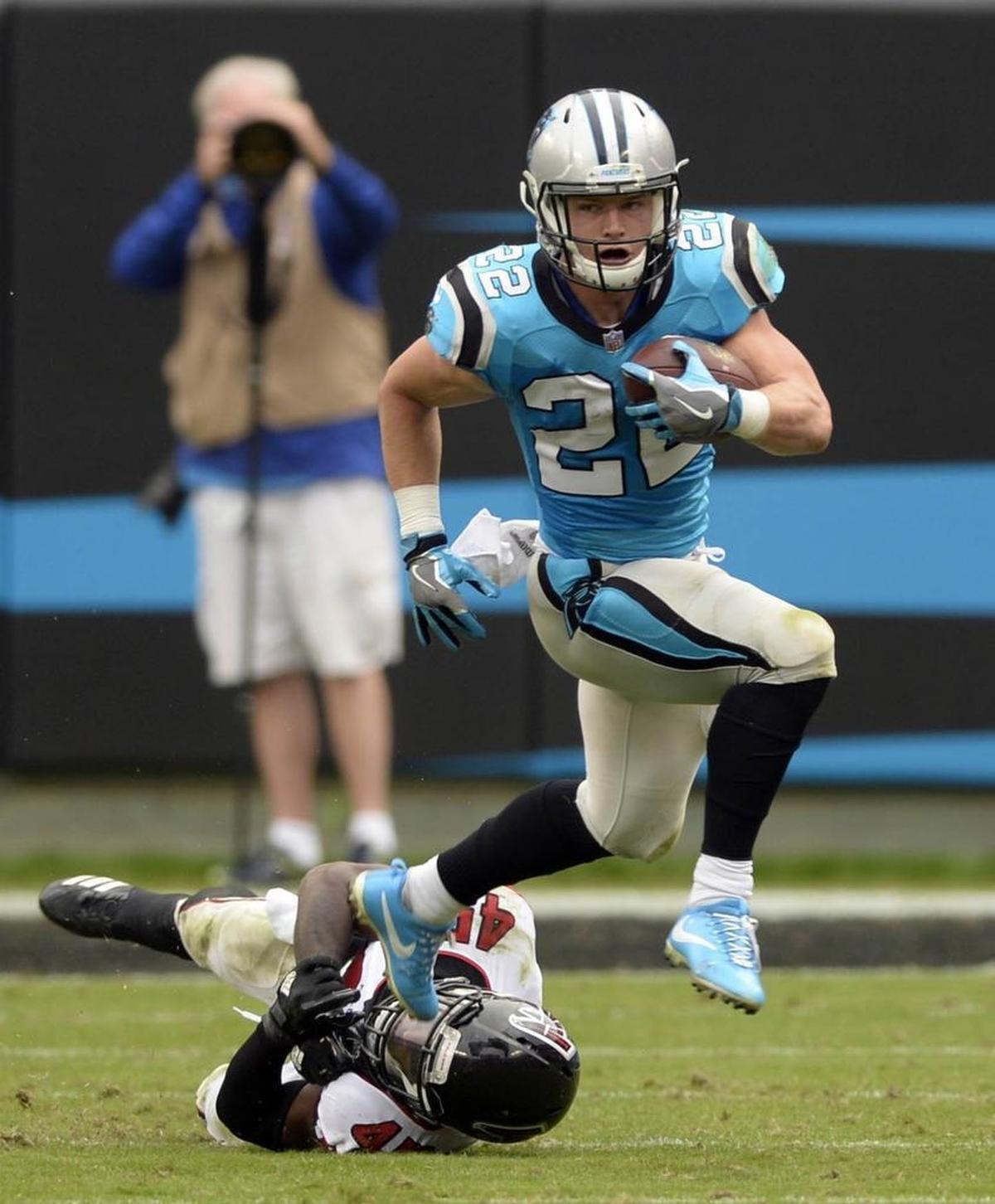 Carolina Panthers running back Christian McCaffrey (22) runs past Atlanta linebacker Deion Jones the first time the two teams met this season, a 20-17 Panthers victory.