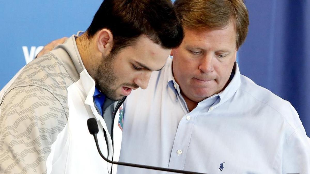 
Florida Gators head coach Jim McElwain, right, puts his arm around quarterback Will Grier as Grier speaks to members of the media Monday in Gainesville, Fla. Grier has been suspended indefinitely for violating the NCAA's policy on banned performance-enhancing drugs. The school announced the suspension at the news conference. Grier, who failed a drug test, said he took an over-the-counter supplement. 
