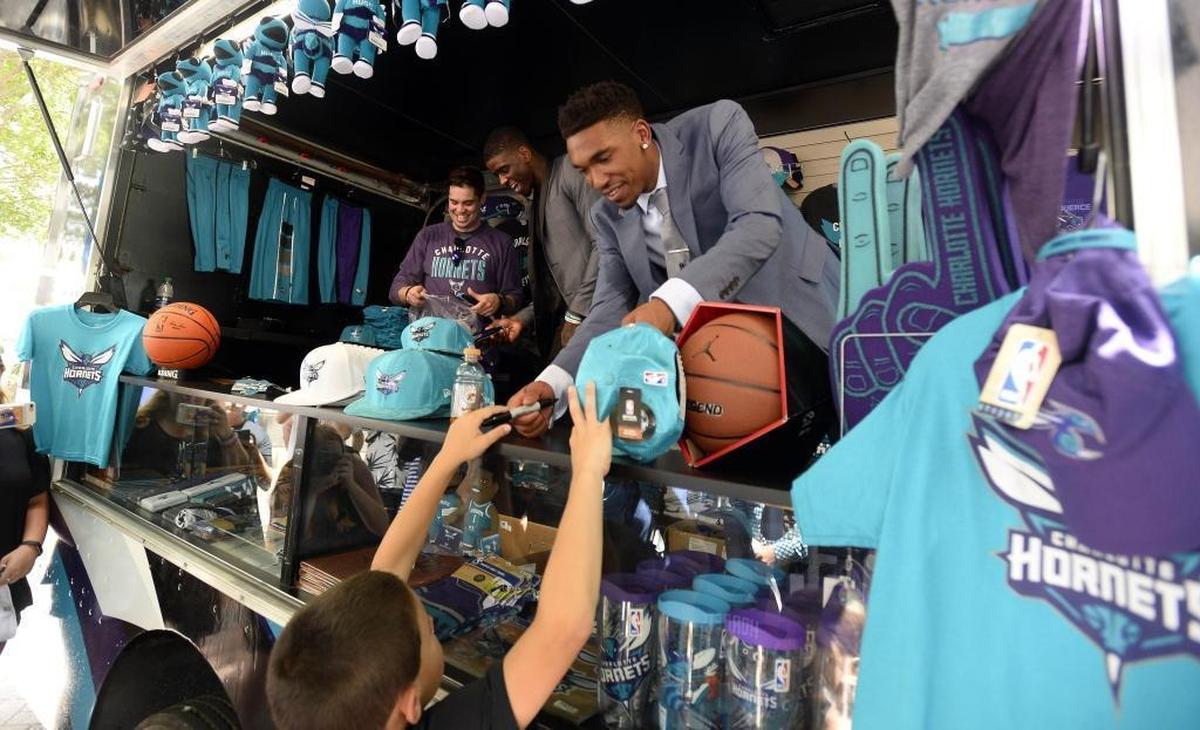 Charlotte Hornets 2017 draft picks Malik Monk, center, hands an autographed hat back to a fan in uptown Charlotte Friday.