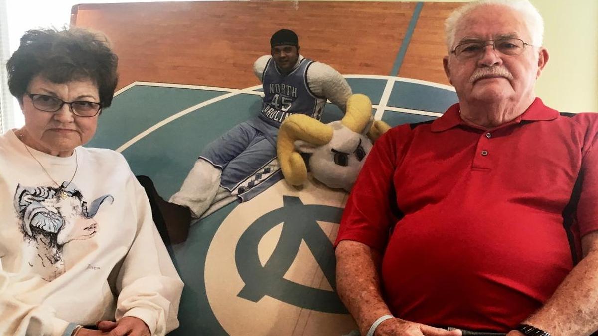 Charlotte Ray (left) and Emmitt Ray sit in front of a picture of their son Jason Ray in his mascot costume at the Smith Center. Jason Ray played Rameses, the UNC mascot, at sporting events for three years during his collegiate career. Jason Ray was killed when he was accidentally run over by a car in New Jersey in 2007.