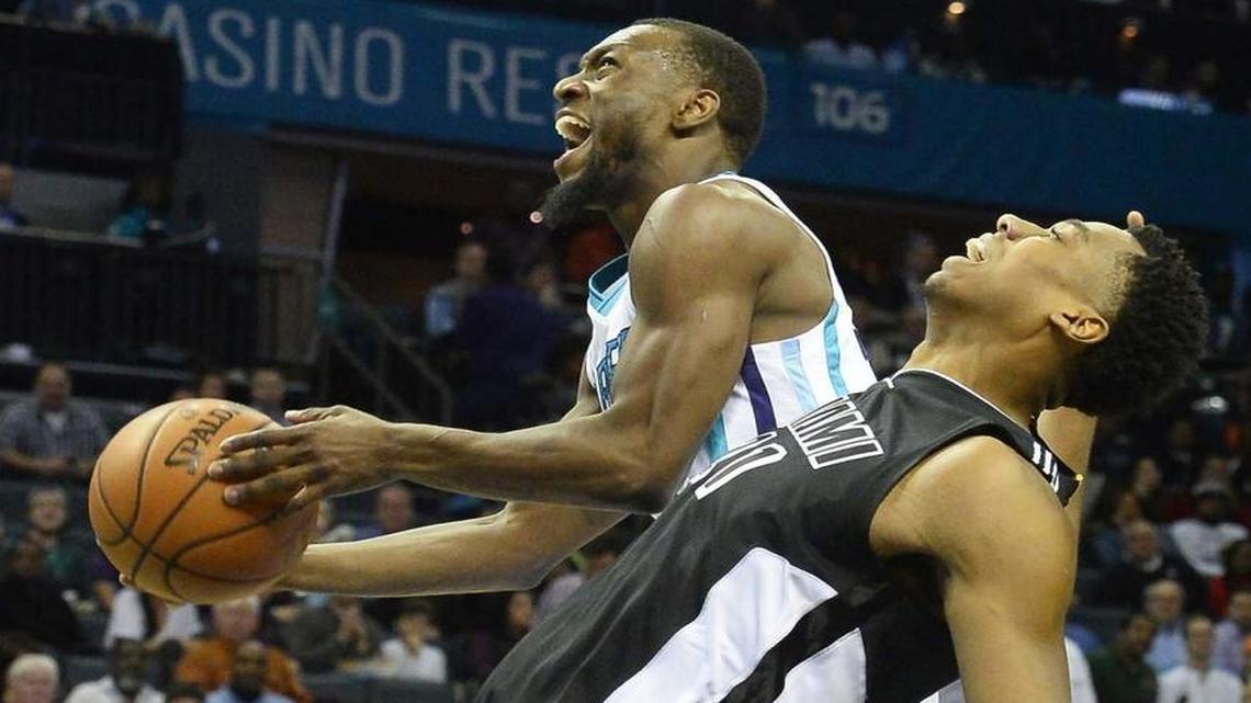 Charlotte Hornets guard Kemba Walker drives the ball to the basket against Miami Heat's Hassan Whiteside during a December game. The Heat and Hornets split their regular-season series, 2-2.