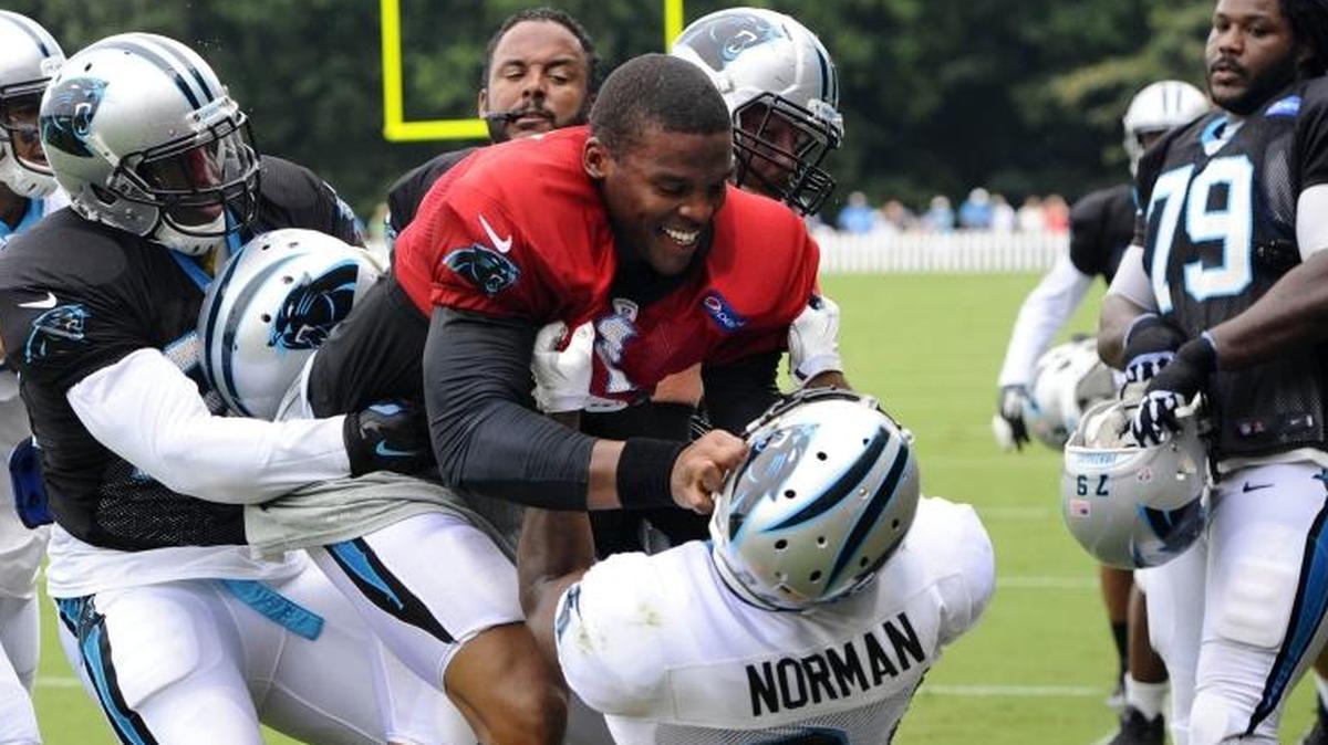 In 2015, Cam Newton (in red jersey) and Josh Norman (24) scuffled at Panthers training camp. The two face off on opposite sidelines again Sunday when Carolina plays at Washington. Newton is 4-0 in his career against Washington.