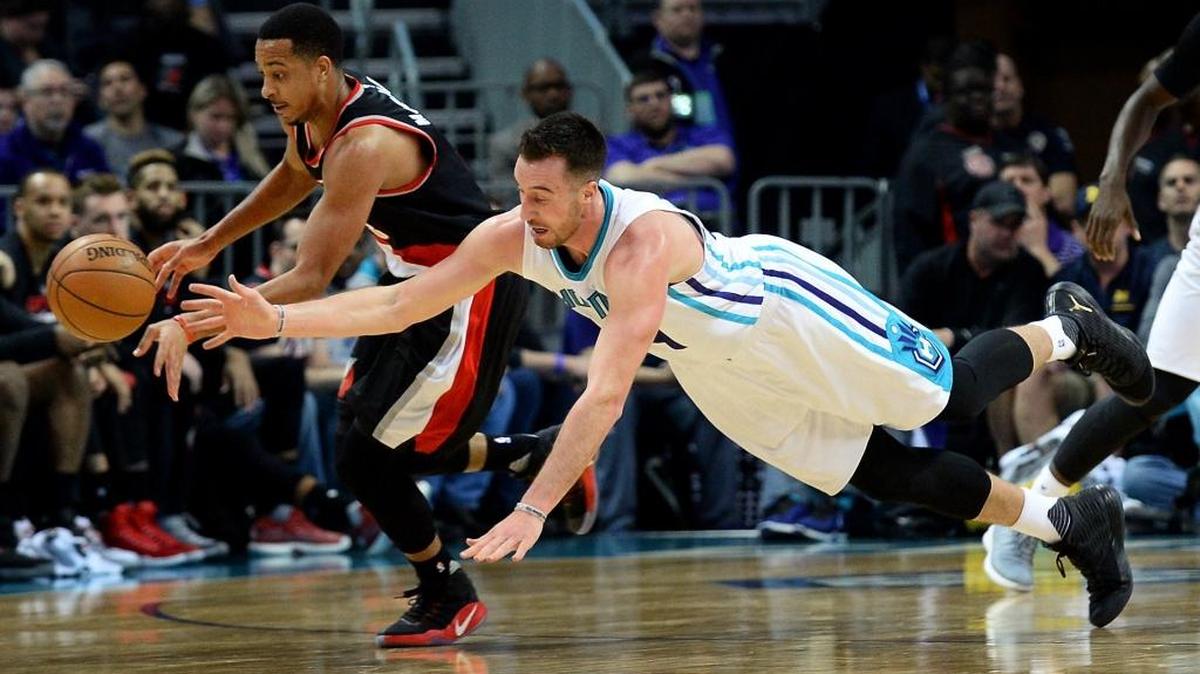 Charlotte Hornets forward Frank Kaminsky (right) tries to gain control of a loose ball Wednesday night against Portland. The Hornets won 107-85, holding an opponent under 100 points for the first time in their past nine games.