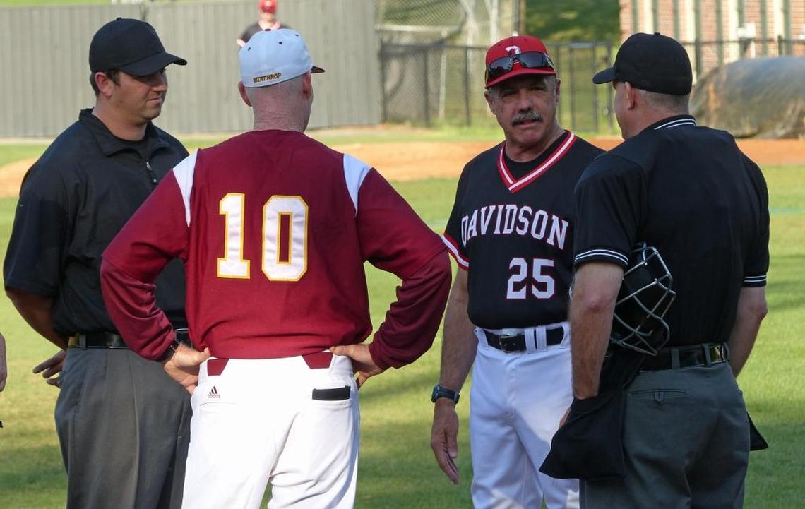 Davidson baseball coach Dick Cooke (second from right) talks with Winthrop coach Tom Riginos (second from left) and two umpires before the start of a 2015 game in Davidson.